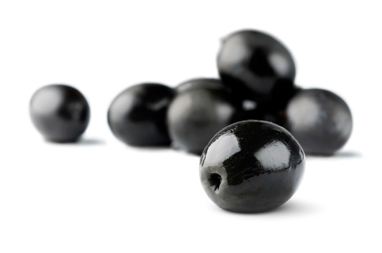 Black olives isolated on white, selective focus